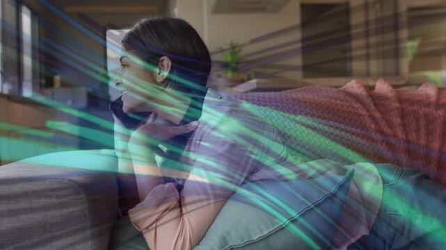 Teen girl lying on sofa chatting on phone, call starting teal tech streaks sweeping overlaying her