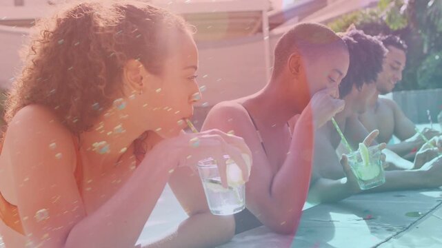 Four adults leaning poolside with glasses after second woman laughing, overlays sweeping lifestyle