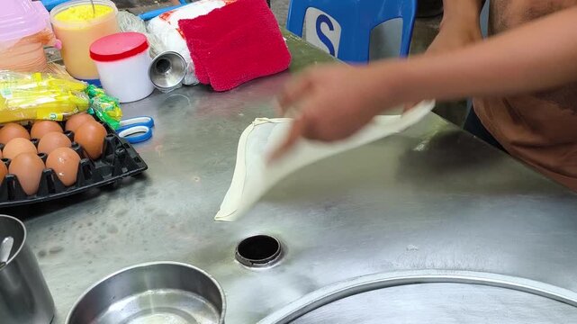 The process of making roti, a Thai street food dish.