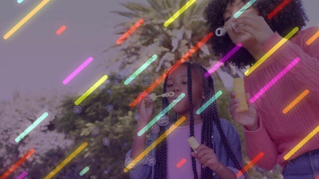Adult showing wand in park urging child to mimic, making family bubbles with diagonal light streaks