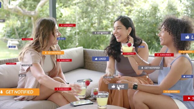 Right woman raising glass, 3 friends toasting on patio as social media overlays popping and fading