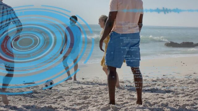 Four adults responding to rolling soccer ball on beach, passing for sport while overlays appearing
