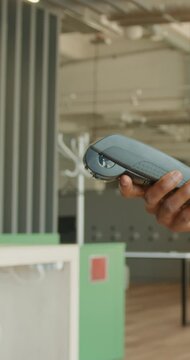 Black receptionist taps contactless terminal in office reception