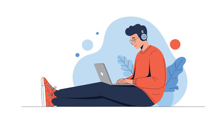 Fototapeta premium Young man sitting comfortably on the floor while working on his laptop wearing headphones against a blue background with plants.