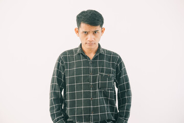Obraz premium close-up of a man wearing a dark green and black plaid flannel shirt with soft lighting. ideal for business, marketing, or communication concepts with a neutral expression.