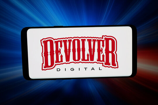 Stuttgart, Germany - 04-23-2026: In this photo illustration, the logo of US video game company Devolver Digital Inc. is displayed on a smartphone in front of abstract background on computer screen.