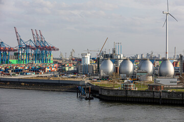 Fototapeta premium Hamburg port industry and logistics with wind turbine