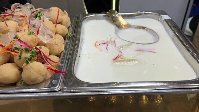 Chilled Dahi Vada (lentil dumplings) soaked in thick, creamy yogurt and generously garnished with aromatic toasted cumin, red chili powder, and fresh coriander.