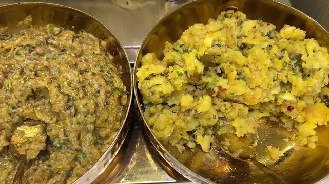 An assortment of traditional Baingan (brinjal) and Alu (potato) Chokha, featuring fire-roasted mashed vegetables seasoned with mustard oil and aromatic spices, served as a side for Litti.