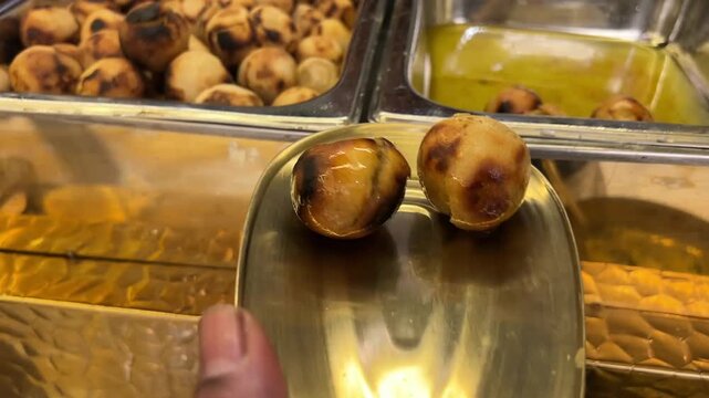 A royal Bihari delicacy: Authentic ghee-dipped Litti Chokha served in traditional golden brass utensils at a luxury Indian wedding, showcasing the rustic flavors of North India.
