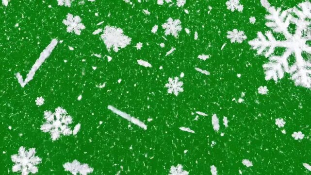 Isolated snowflakes falling against a green screen for background use in projects and presentations