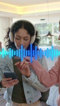 Vertical video: Center woman tapping phone at home starting blue waveform wearing headset singing