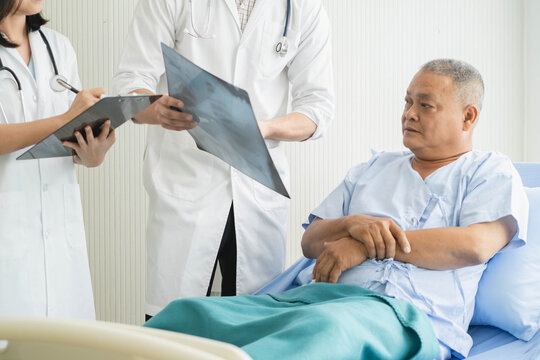 Doctor explaining result of radiography test to patient.