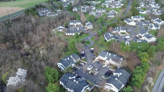 Curved street cluster forms compact subdivision loop south of Old York Rd in Three Bridges. Repeating rooflines, manicured lawns, soft spring illumination produce consistent textures, New Jersey