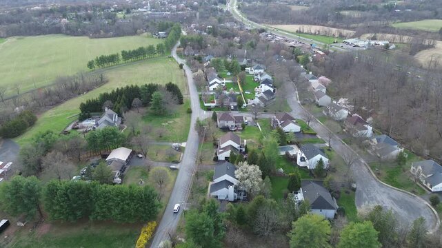 Semi rural neighborhood edge appears south of Old York Rd near US 202 approach Readington Township. Varied shingles, open fields, early spring foliage layered textures, Three Bridges, New Jersey