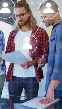 Vertical video: Colleagues reviewing document at glass table for business, network icons overlaying
