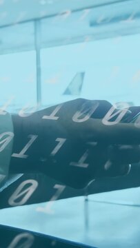 Vertical video: Hands lifting phone from armrest as digits sweep, thumbs swiping flight info window