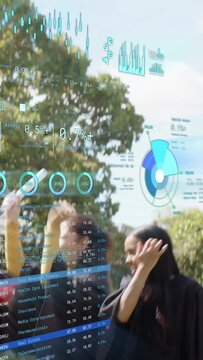 Vertical video: Grad group on lawn tossing caps while camera panning, starting data HUD over group