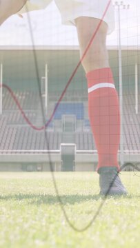 Vertical video: soccer player pushing ball right foot, dribbling as waves crossing player, prepping