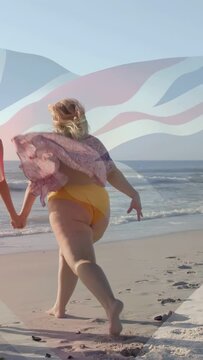 Vertical video: Woman sprinting after seeing surf, jumping while holding pal, walking for travel