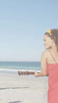 Vertical video: Glitch clearing revealing beach while woman walking strumming guitar making music