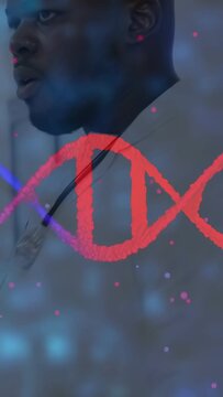 Vertical video: Doctor turning head in clinic while helix appearing and highlighting DNA data