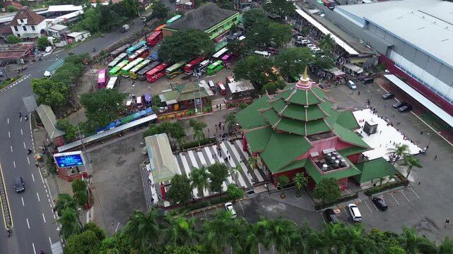 Aerial view of a green tiered roof building and bus terminal