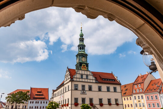 Town hall with clock tower framed by an arch in Pirna Germany