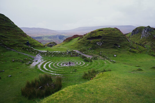Celtic grass labyrinth in the green Scottish Highlands landscape