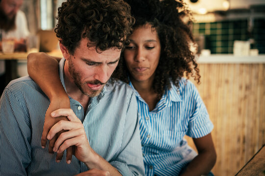 Couple holding hands and sitting at cafe