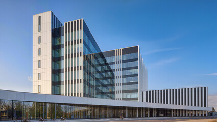 Fototapeta premium Modern Business Architecture with Glass Facade and Blue Sky