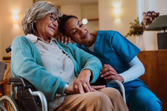Caregiver providing compassionate assistance to elderly in wheelchair