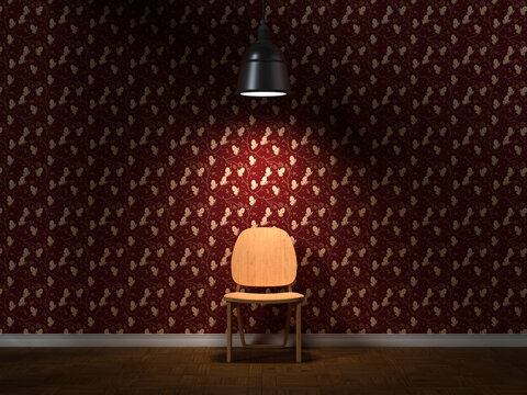 Empty wooden chair under spotlight in a dark room