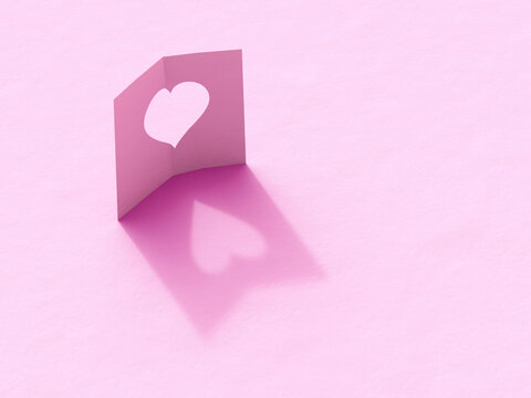 3D folded pink paper card with heart cutout and shadow