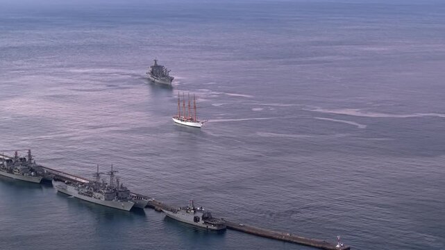 Aerial orbit of Chilean Navy warships in Valparaiso Bay with the training ship La Esmeralda, at dawn, Chile