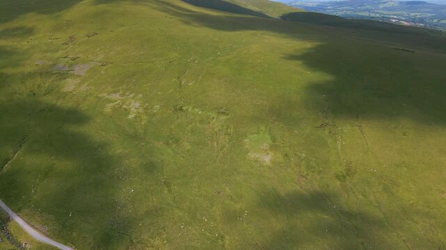 Cloud Shadow Pattern on Green, Grassy Hillside - High Angle Aerial
