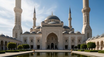 Fototapeta premium Large white mosque with blue domes and tall minarets on a sunny day