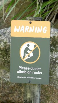 Warning Sign Prohibiting Climbing on Rocks in a Wallaby Habitat