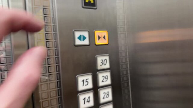 Close Up of Hand Pressing First Floor Button in Modern Elevator