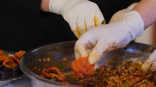 Stuffed vegetables are carefully arranged in a pot in an organized manner. The process highlights traditional cooking preparation, attention to detail, and structured layering in a kitchen environment