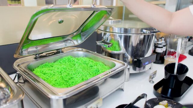 Serving Thai Green Jade Noodles from a Stainless Steel Chafing Dish