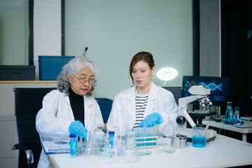 Fototapeta premium Scientists in laboratory conducting research, analyzing samples with microscope and data, healthcare innovation, medical testing