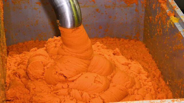 The container is filled with bright orange carrot puree.