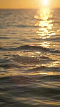 Ultra realistic close-to-surface ocean waves shimmer in golden sunset light, cinematic macro water detail perfect for travel marketing, relaxation visuals, or luxury branding content