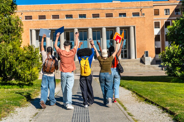 Obraz premium Diverse students celebrating success on university campus