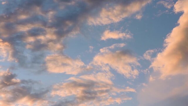a scenic sunset sky filled with soft, glowing clouds against a tranquil blue backdrop