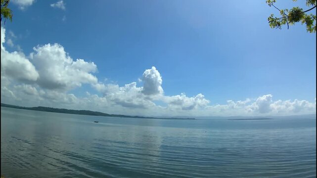 clouds over the sea. island, mountains. time lapse