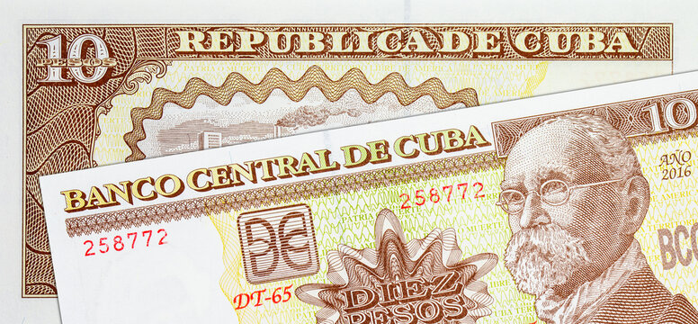 10 Pesos Cuba image of national flags and soldiers with Kalashnikov assault rifles. Paper money Cuba.