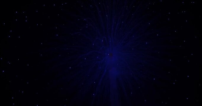 Blue fiber optic burst with glowing dots and soft trailing light abstract night trail of glowing dots, colorful firework burst and bright sparks creating festive celebration energy