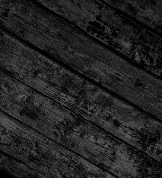 Alte verwitterte diagonale schwarze Holzbretter